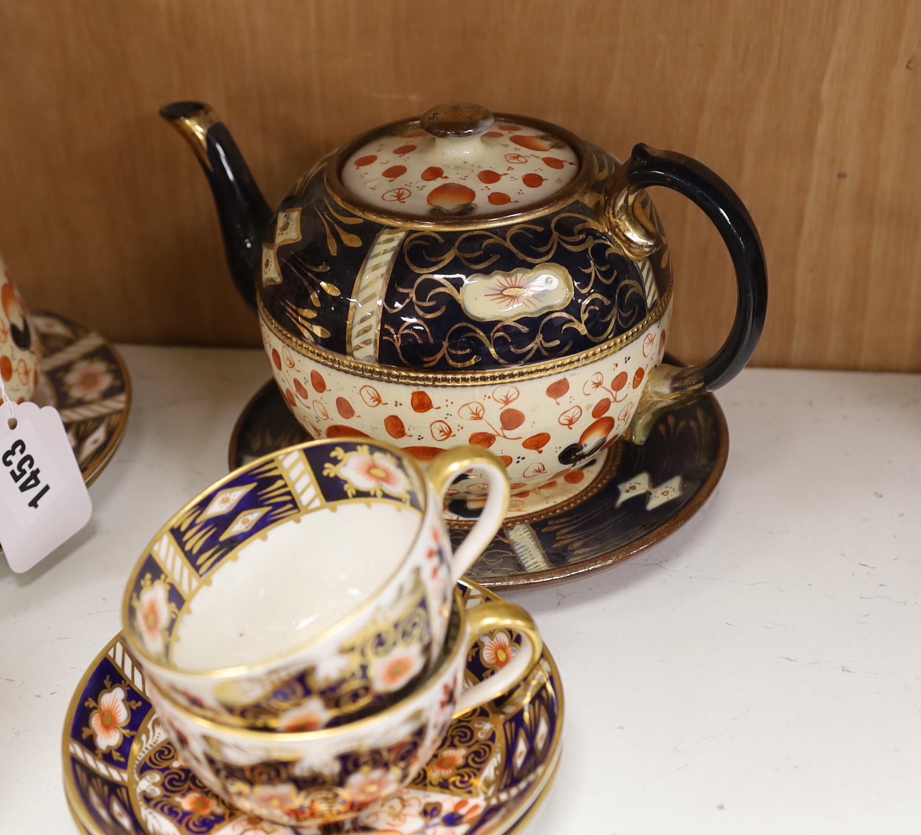 A Royal Crown Derby Imari pattern 2451 part tea set together with an Imari style jug, teapot and stand, largest 18cm high